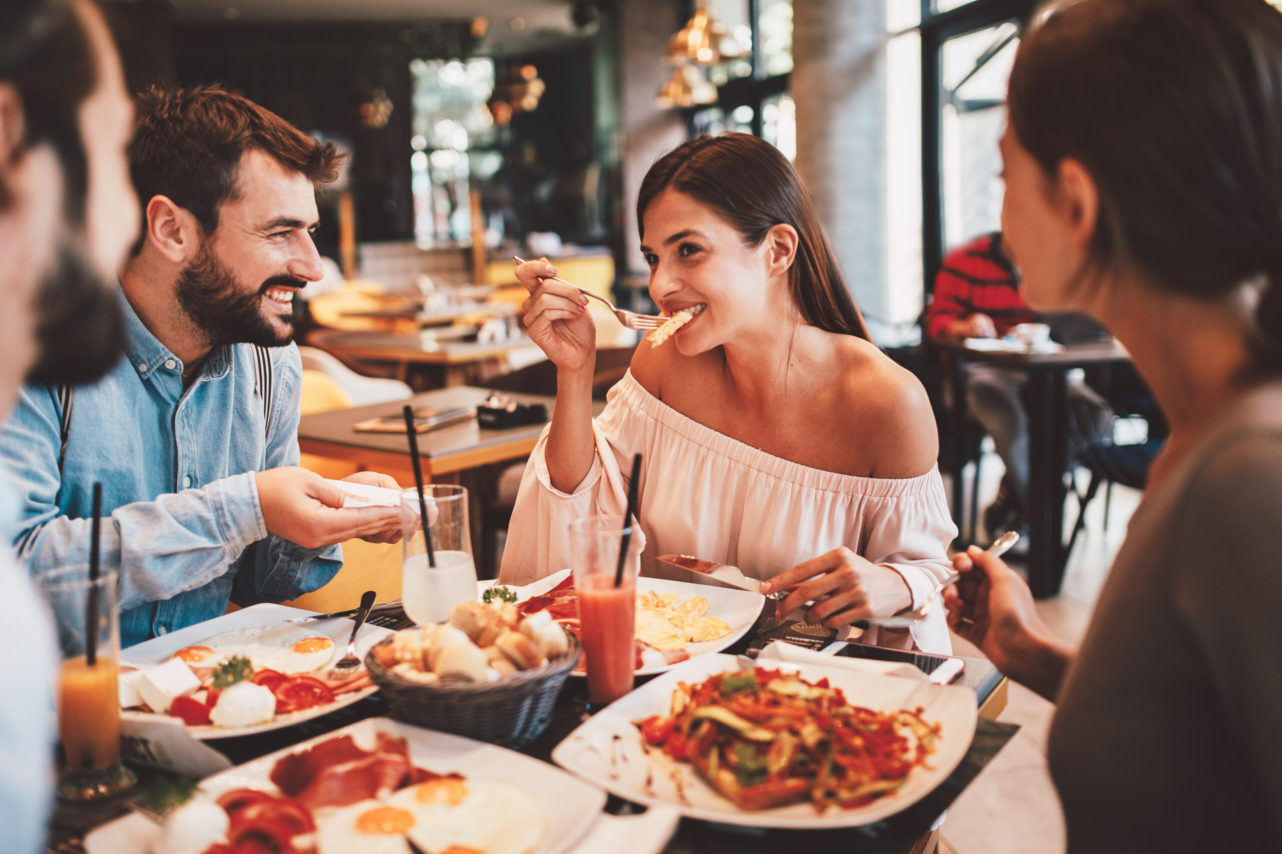 Group of Happy friends having breakfast in the restaurant